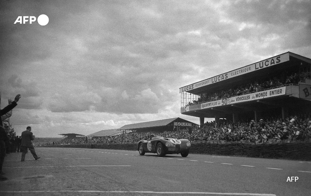 The Jaguar Type-C XK 120 car crosses the finish line, 1953