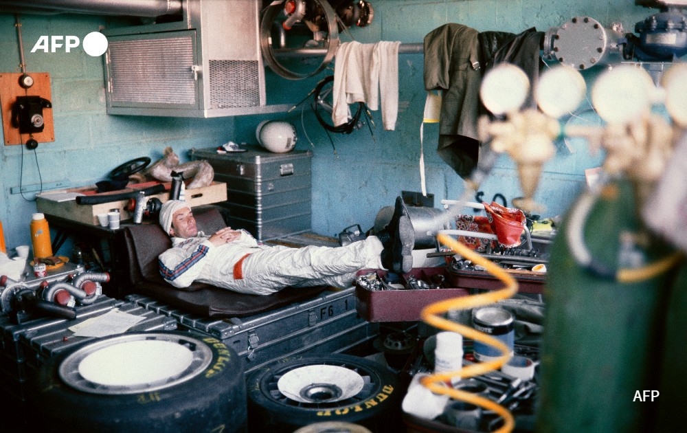 A race driver takes a rest at the Porsche pit, 1978