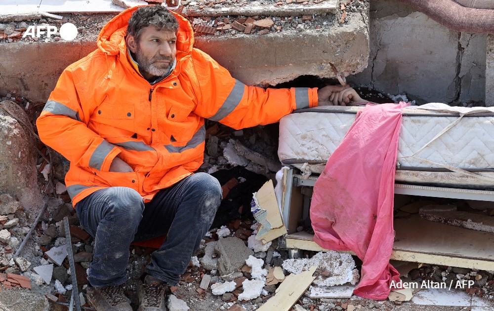 A man holds the hand of his 15-year-old daughter Irmak, who died in the earthquake in Turkey.