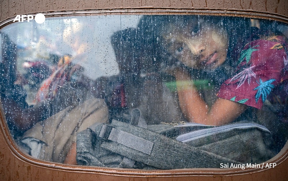 A girl looks outdoor in a tuk tuk evacuating ahead of the arrival of Cyclone Mocha