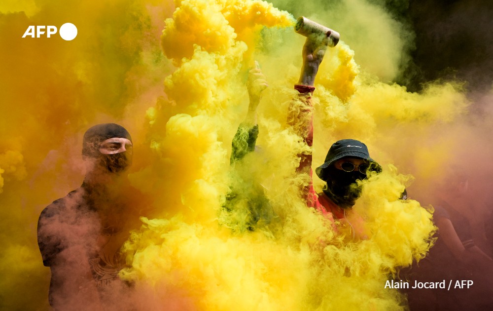 Protestors light flares during a demonstration, France