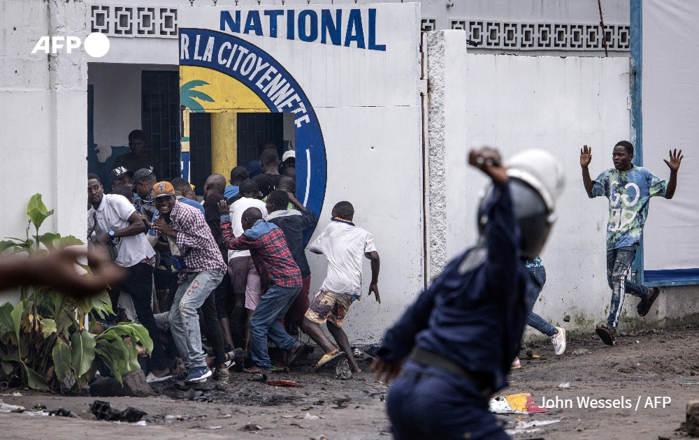 A Police officer throws a rock