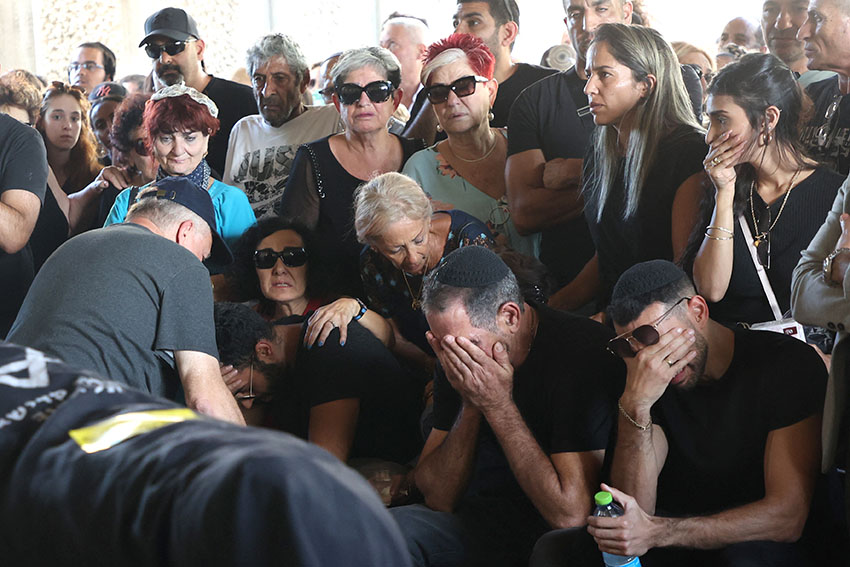 Relatives mourn the body of Israeli-French citizen Celine Ben David Nagar at her funeral near Tel Aviv on October 17, 2023, after she was killed in the October 7 attack by Hamas militants. Photo by Gil Cohen Magen / AFP.