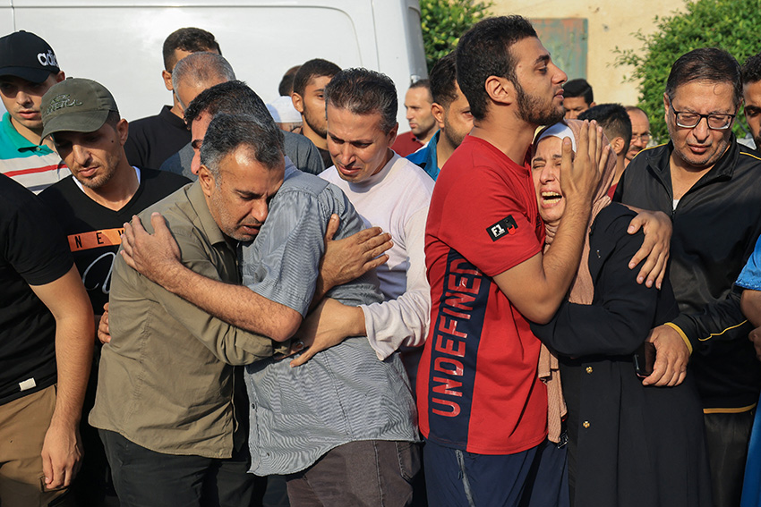 People mourn during the funeral of members of the Abu Morad family, who died following Israeli strikes in Khan Yunis in the southern Gaza Strip on October 24, 2023. Photo by Mahmud Hams / AFP