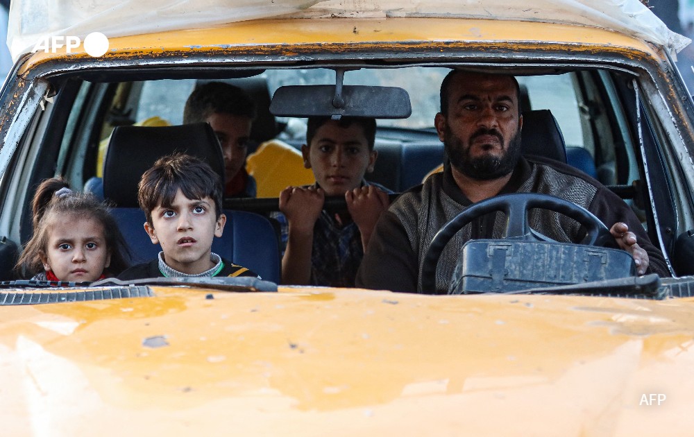 Residents of a refugee camp in a car 