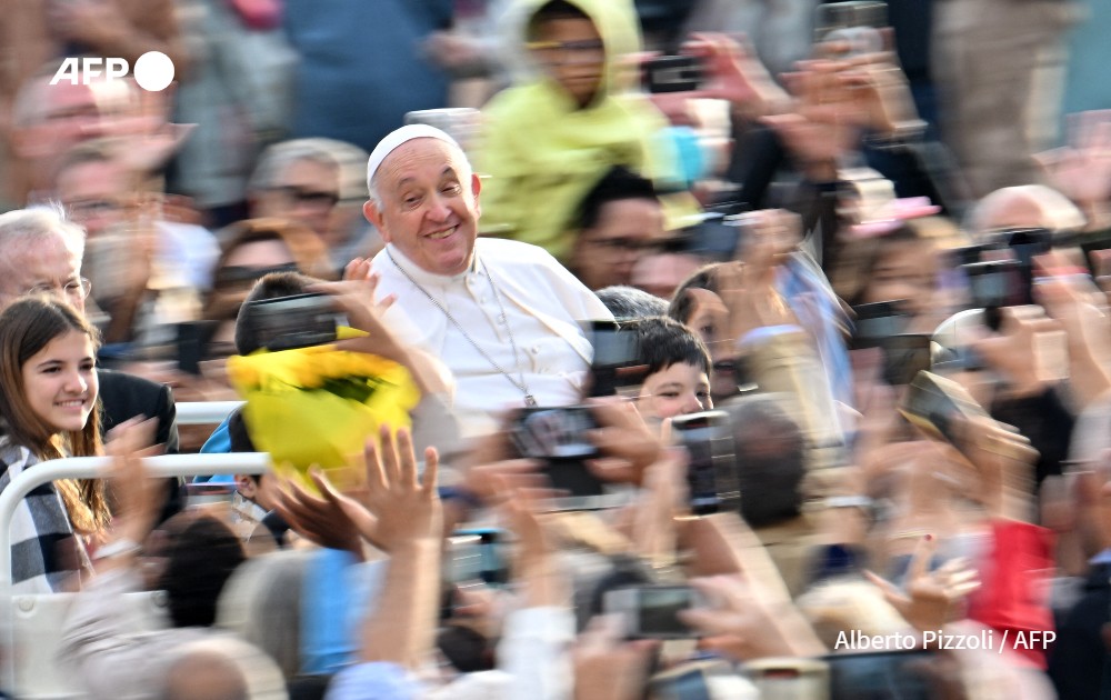 Pope Francis waves to the crowd